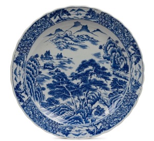 An antique Japanese Arita Ware blue and white charger with landscape scene, Meiji Period, 40cm diameter