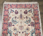 A Persian hand-knotted floral runner with pink and cream ground, remains of Hali Rug Gallery label verso, 333 x 80cm - 2