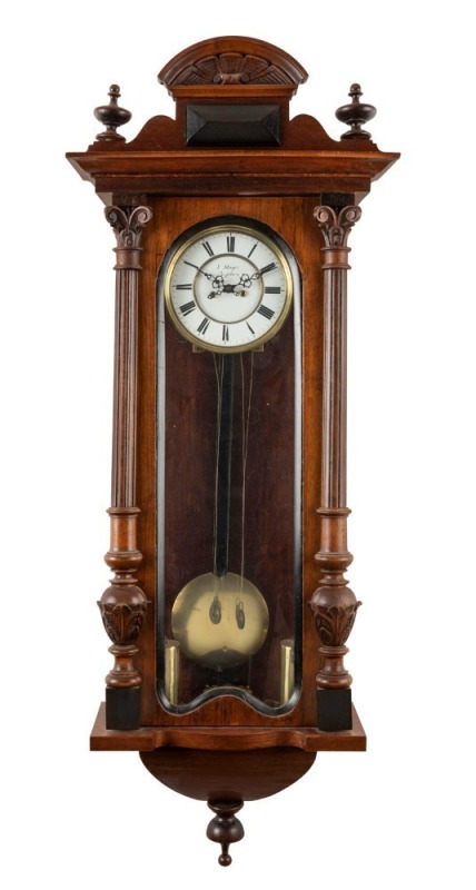 An antique Vienna regulator wall clock in walnut case, late 19th century, with pendulum and key, 110cm high