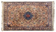 A Persian hand-knotted wool rug with fine floral motif on beige and blue ground, 200 x 127cm