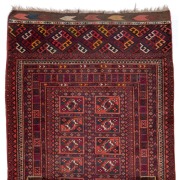 An impressive Turkoman runner with geometric pattern on red ground, 620 x 100cm