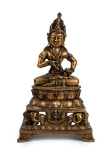Buddha Sharvari Vajra seated bronze Tibetan Buddha with gilt finish holding a vajra, 18th/19th century, with inscription on the reverse, 37cm high