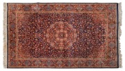 A Pakistani hand knotted pure wool rug with ornate floral motif on blue ground.230 x 144 cm