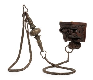 A bronze Toda buffalo bull necklace. A rare and old ceremonial tribal piece used in special religious festivals by the Toda tribe from the Nilgiri Hills, Tamil Nadu, South India, 19th century. Accompanied by an ornate carved wooden bracket from which to suspend the necklace. 188cm long, 1,250 grams. PROVENANCE: Private Collection, Melbourne. Acquired Bombay (Mumbai), 22 May 1987.