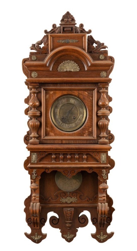 An antique American wall clock in ornate walnut case with gilt metal adornments, 8 day time and strike movement with engraved metal dial and pendulum, 19th century, 101cm high