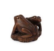 An antique Japanese carved boxwood netsuke of two frogs on a lotus leaf, signed Katakuni, Meiji period, 19th century, ​​​​​​​3cm high, 4.8cm wide