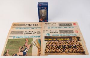 1974-1977 "The Herald" Grand Final souvenir editions comprising 1974 (Richmond premiers), 1975 (North Melbourne premiers), 1977 (2, Collingwood v North Melbourne, drawn GF); also AFL Collectable product 2012 Premiership Cup (Sydney Swans) in box; condition variable. (5 items)