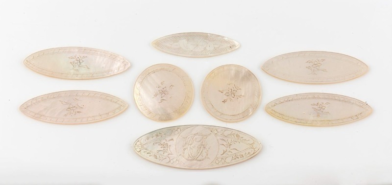 Eight antique Chinese carved mother of pearl gaming tokens, 19th century, the largest 6cm wide