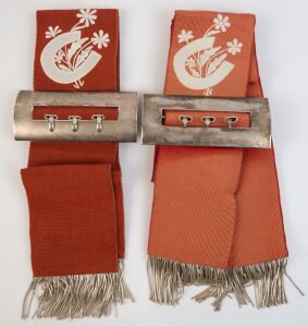 1954 & 1957 SOUTH AUSTRALIAN ST LEGER: Winner's sashes with metallic braided tassels and sterling silvers buckles, the former stamped, 'C.W. Ottaway & Co, Adelaide", total buckle weight, 570gr. (2 items)
