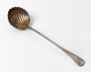 A Georgian sterling silver ladle with shell-shaped bowl, beadwork edging and engraved crest. Made by William Chawner II of London, circa 1824, 36cm long, 190 grams