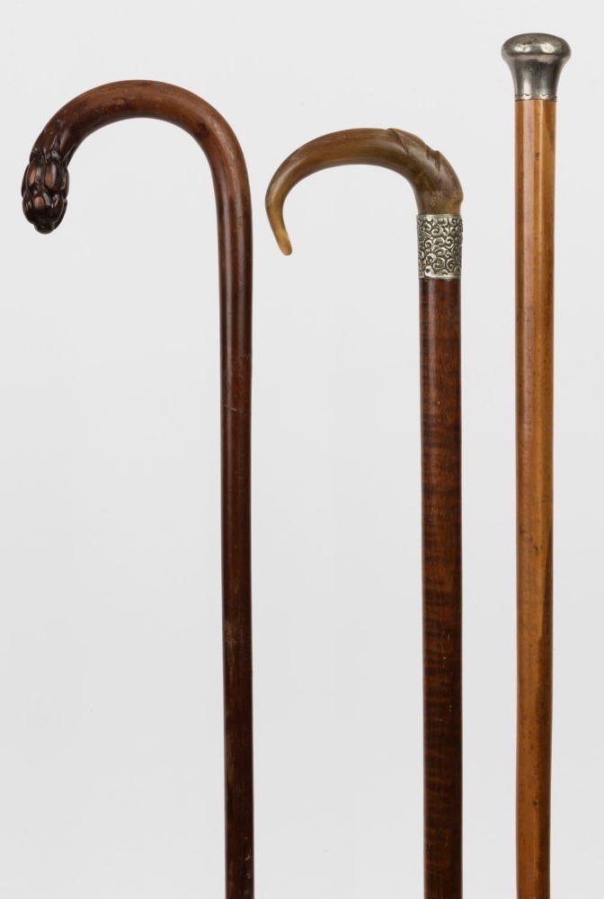 Three antique walking sticks, fiddleback blackwood, Malacca and carved ...