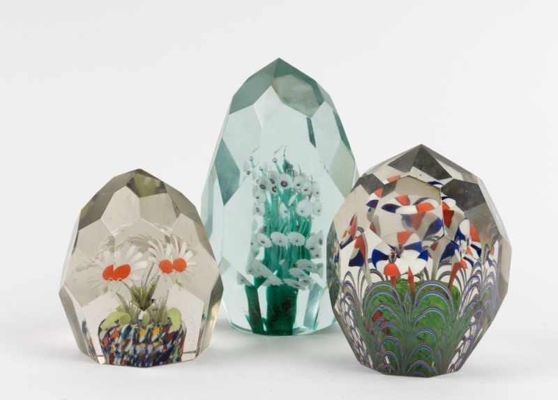 Three Murano glass paperweights with coloured floral inclusions and faceted finishes, 20th century, 14cm, 10cm and 9cm high