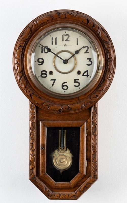 An American drop-dial oak cased wall clock with 8 day time and strike movement, Arabic numerals and convex glass, early 20th century, ​​​​​​​56cm high