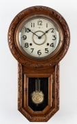 An American drop-dial oak cased wall clock with 8 day time and strike movement, Arabic numerals and convex glass, early 20th century, ​​​​​​​56cm high