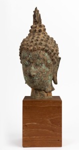 A bronze Buddha head on timber stand26cm high, 45cm high overall