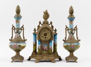 An antique three piece clock set in gilt metal and porcelain case with matching garnitures, time only movement, later carved wooden finials, 19th/20th century, ​​​​​​​the clock 42cm high