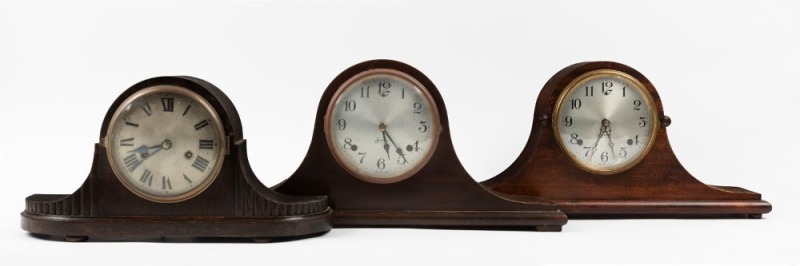 Three timber cased Napoleon hat mantel clocks with twin train time and strike movements, 20th century, ​​​​​​​the largest 24cm high, 54cm wide