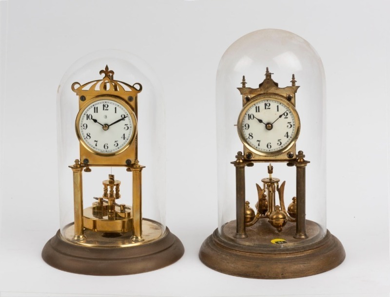 Two German 400 day anniversary clocks in glass domes, 20th century, 29cm and ​​​​​​​30cm high each overall