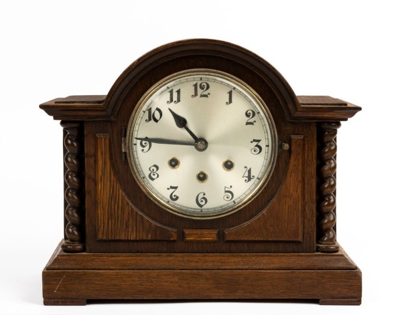 A German Tudor style oak cased mantel clock with triple train time, strike and chiming movement, circa 1920s, ​​​​​​​28cm high