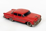 MODERN TOYS (MASUDAYA): Radicon New Sedan, tinplate battery operated model (missing the antenna & the radio control) ,finished in red with chrome trim; length 35cm, c.1950s.