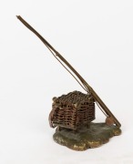 FISHING ROD & BASKET PAPERWEIGHT: in brass with the basket weaving and fishing line in copper, height 14cm, early 20th century. 