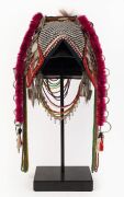 AKHA 'PHAMI' HEADDRESS: Made from Yunnan "Dragon" coins, 19th century Burmese glass beads, hand-made silver moon-shaped buttons, chains, pendants, tassels; gibbon fur; red-dyed chicken hackles and horsehair. circa 1930s. - 2