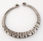 An antique Indian tribal silver torque neckring (hussli), border of the Sind/Indus Valley, Rajasthan, 19th/20th century. Cast solid silver, finely chased and incised with various lobes and geometric patterns. 15cm wide, an impressive 663 grams total, (23. - 2