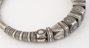 An antique Indian tribal silver torque neckring (hussli), border of the Sind/Indus Valley, Rajasthan, 19th/20th century. Cast solid silver, finely chased and incised with various lobes and geometric patterns. 15cm wide, an impressive 663 grams total, (23. - 5