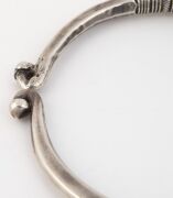 An antique Indian tribal silver torque neckring (hussli), border of the Sind/Indus Valley, Rajasthan, 19th/20th century. Cast solid silver, finely chased and incised with various lobes and geometric patterns. 15cm wide, an impressive 663 grams total, (23. - 10