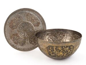 Antique Vietnamese silver finished presentation bowl, Northern Vietnam, Nguyen Dynasty, 19th century. The body finely decorated in repousse with four cartouches containing Buddhist symbols. The lid centre with shou character (longevity) surrounded by four medallions depicting floral designs of peonies, bamboo, prunus and chrysanthemum, (representing the four seasons). Marked with the numeral "4" on the base. 10cm high, 21cm diameter, 437 grams PROVENANCE: Private Collection Melbourne. Acquired