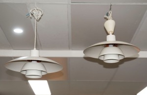 A pair of circular white and orange metal vintage hanging lights, Note: Plugs have been removed, 38cm diameter