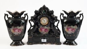 Three piece black floral porcelain clock set, (A/F), 20th century, ​​​​​​​the clock 31cm high