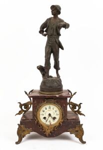 An antique French figural mantel clock with rouge marble case, gilt metal fittings, cast and patinated spelter statue, coloured enamel dial and Arabic numerals, late 19th century, ​​​​​​​55cm high