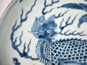 A Chinese blue and white charger with foo dog in landscape decoration, Guangxu Period late 19th century, square seal mark to base, 8cm high, 40cm diameter - 8