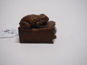 Two antique Japanese carved boxwood netsuke of a toad and a Foo dog, Meiji period, 19th century, the toad 4.8cm wide - 5