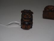 Two antique Japanese carved boxwood netsuke of a toad and a Foo dog, Meiji period, 19th century, the toad 4.8cm wide - 6