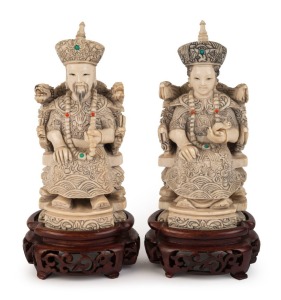 A pair of Chinese carved ivory ancestor statues on carved wooden stands, early to mid 20th century, 18cm high overall