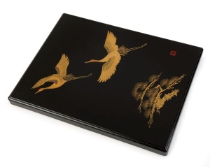 A Japanese lacquer ware document box decorated with flying cranes, 20th century, 2cm high, 18cm wide, 23cm deep