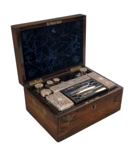 An impressive antique rosewood travel box fitted with lift-out tray housing sterling silver jars and manicure set, all housed in original leather outer case, made in London, circa 1823, 16cm high, 31cm wide, 23cm deep overall