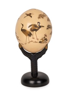 An antique Japanese gold lacquered decorated ostrich egg ornament on original lacquered stand shaped as a bird claw, Meiji period, 19th century, 26cm high. PROVENANCE: Purchased at Christie's Auctions South Kensington, London in the late 1980s for $2000.