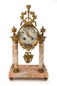 An antique French mantel portico clock, gilt metal and marble with enamel dial, Arabic numerals, and 8 day time and strike moment, 19th century, 39cm high