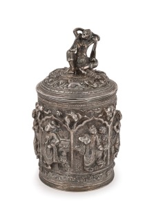 A fine Burmese silver box with repousse decoration and figural finial. 19th/20th century. Note the inclusion of winged angel and lion decoration. 15cm high, 334 grams