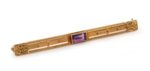 An American 14ct gold bar brooch, set with a cushion cut amethyst, 20th century, stamped "W.A.B. 14K", 6.5cm wide, 5 grams total