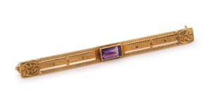 An American 14ct gold bar brooch, set with a cushion cut amethyst, 20th century, stamped "W.A.B. 14K", ​​​​​​​6.5cm wide, 5 grams total