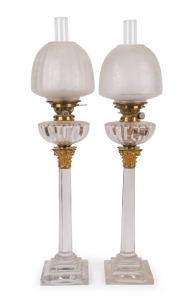 An Impressive pair of English glass banquet lamps with ormolu mounted Corinthian columns and original gadroon moulded fonts, and Hink's patent burners, circa 1890, 85cm high 21cm diameter 