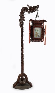 A Chinese standard lamp, ornately carved wood with dragon motif and hanging shade, mid 20th century, 183cm high