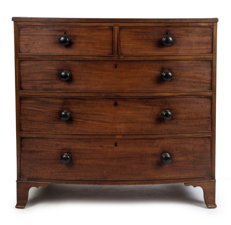 An antique mahogany bow front chest with five drawers, with reeded moulding and original ebony knobs, circa 1830, 103cm high, 107cm wide, 53cm deep