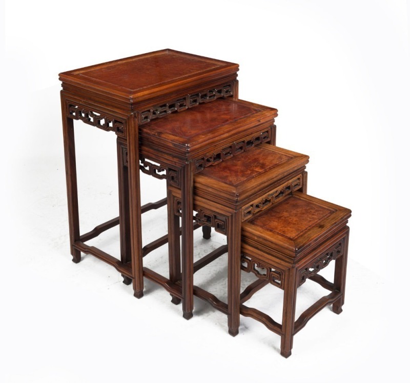 A Chinese nest of four tables, each with rosewood reeded frames and pierced scroll frieze below a fielded burr wood panel top, circa 1890, the larger 69cm high, 48cm wide, 34cm deep