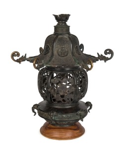 An antique Chinese cast bronze temple lantern, 18th century, later wooden plinth, 50cm high, 46cm wide