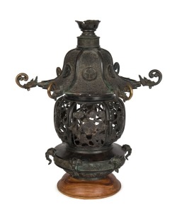 An antique Chinese cast bronze temple lantern, 18th century, later wooden plinth, 50cm high, 46cm wide